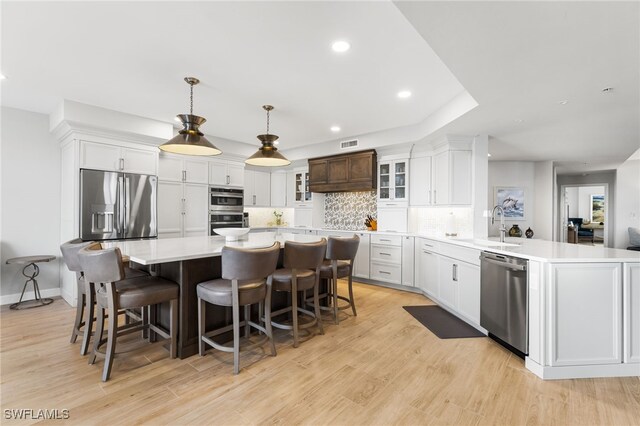 14250 Royal Harbour Ct Unit 913, Fort Myers, FL 33908 - kitchen featuring appliances with stainless steel finishes, decorative backsplash, light countertops, a sink, and white cabinetry