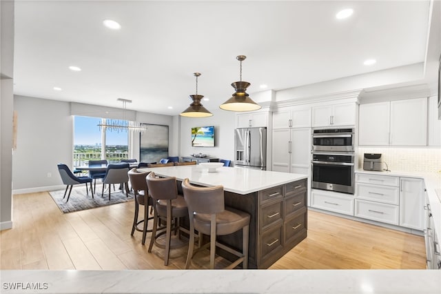 14250 Royal Harbour Ct Unit 913, Fort Myers, FL 33908 - kitchen featuring stainless steel appliances, white cabinetry, light countertops, recessed lighting, and a center island
