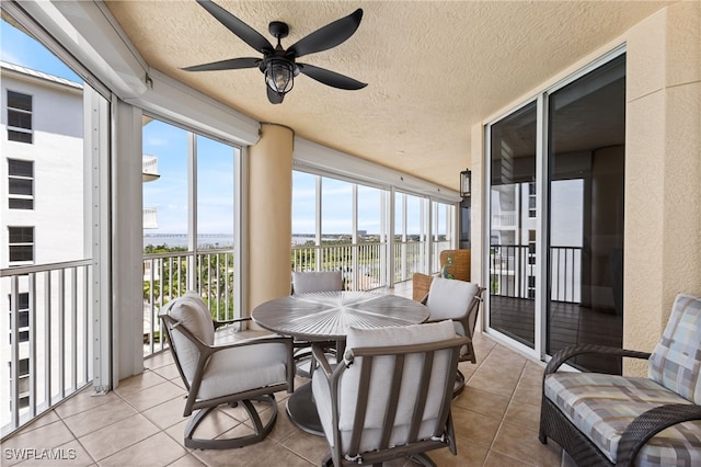 14250 Royal Harbour Ct Unit 913, Fort Myers, FL 33908 - sunroom / solarium featuring tile patterned floors, a wall of windows, healthy amount of natural light, a water view, and a textured ceiling