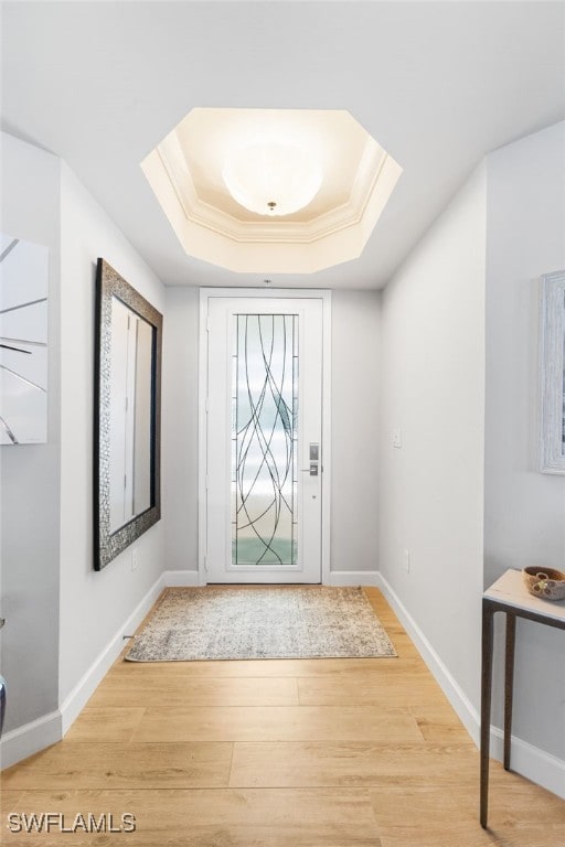 14250 Royal Harbour Ct Unit 913, Fort Myers, FL 33908 - entryway with a tray ceiling, wood finished floors, crown molding, and baseboards