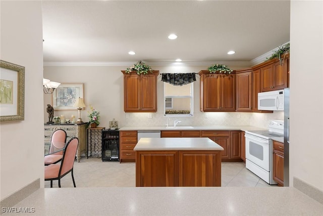 28666 San Lucas Ln Unit 102, Bonita Springs, FL 34135 - kitchen with crown molding, white appliances, light countertops, light tile patterned floors, and tasteful backsplash