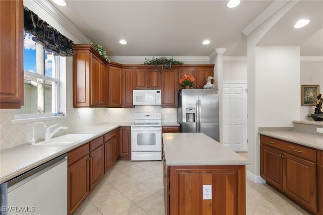 28666 San Lucas Ln Unit 102, Bonita Springs, FL 34135 - kitchen featuring backsplash, a sink, light countertops, ornamental molding, and white appliances