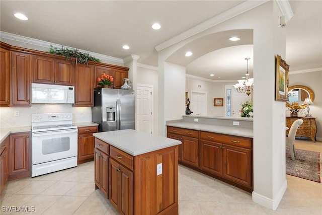 28666 San Lucas Ln Unit 102, Bonita Springs, FL 34135 - kitchen featuring ornamental molding, white appliances, light countertops, arched walkways, and a notable chandelier