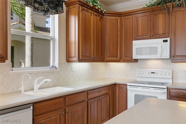 28666 San Lucas Ln Unit 102, Bonita Springs, FL 34135 - kitchen featuring tasteful backsplash, brown cabinets, a sink, light countertops, and white appliances