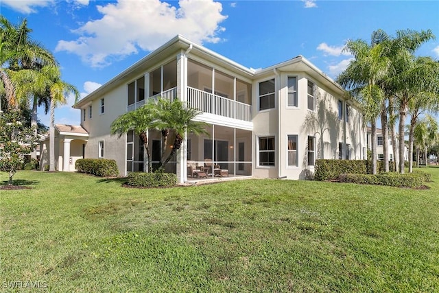 28666 San Lucas Ln Unit 102, Bonita Springs, FL 34135 - back of property with a lawn, stucco siding, and a sunroom