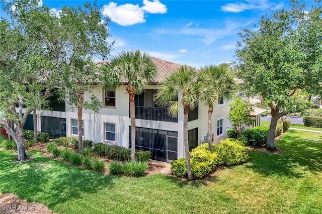 4651 Turnberry Lake Dr Unit 201, Estero, FL 33928 - back of house with a yard, a balcony, and stucco siding