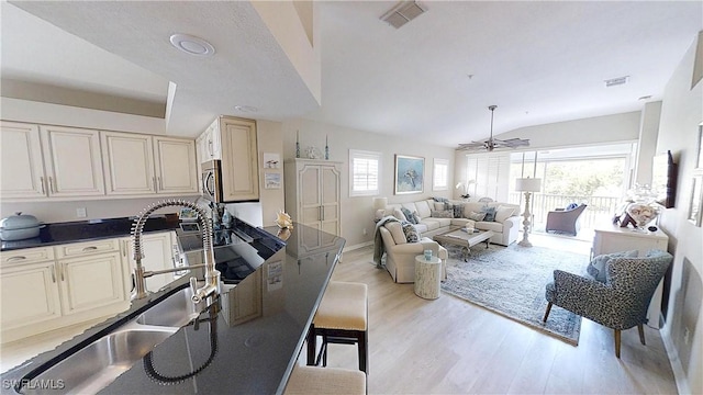 6805 Satinleaf Rd S Unit 201, Naples, FL 34109 - living area featuring visible vents, ceiling fan, vaulted ceiling, and light wood-type flooring