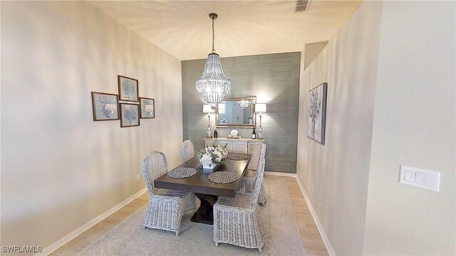 6805 Satinleaf Rd S Unit 201, Naples, FL 34109 - dining space featuring visible vents, light wood-style floors, a chandelier, and baseboards