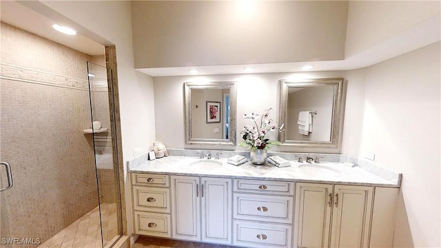 6805 Satinleaf Rd S Unit 201, Naples, FL 34109 - bathroom featuring a shower stall, double vanity, and a sink