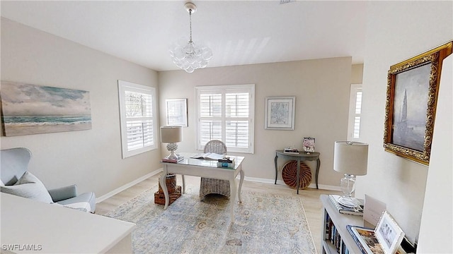 6805 Satinleaf Rd S Unit 201, Naples, FL 34109 - office featuring baseboards, an inviting chandelier, and light wood-style floors