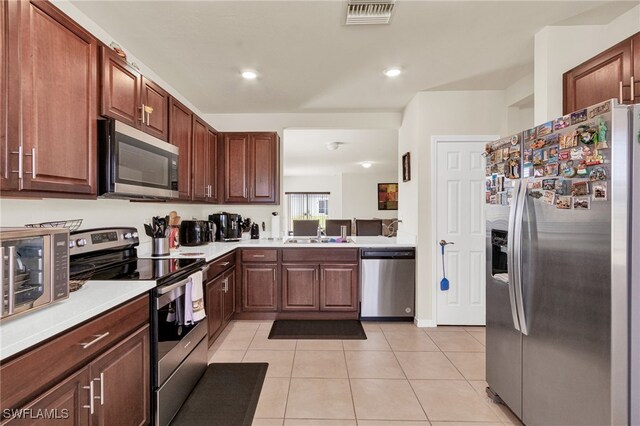 226 NW 4th Ter, Cape Coral, FL 33993 - kitchen featuring light tile patterned floors, visible vents, stainless steel appliances, and light countertops