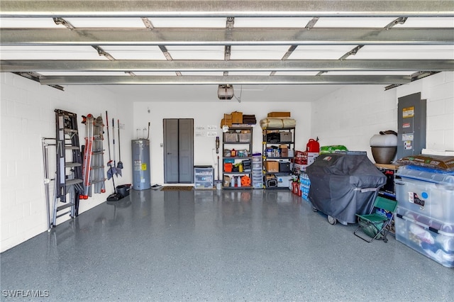 226 NW 4th Ter, Cape Coral, FL 33993 - garage with water heater, concrete block wall, and electric panel