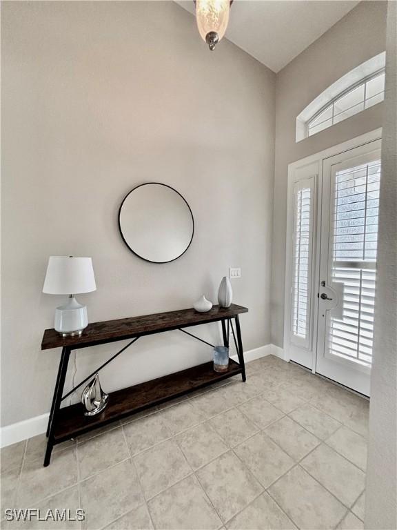 entrance foyer with baseboards and light tile patterned floors