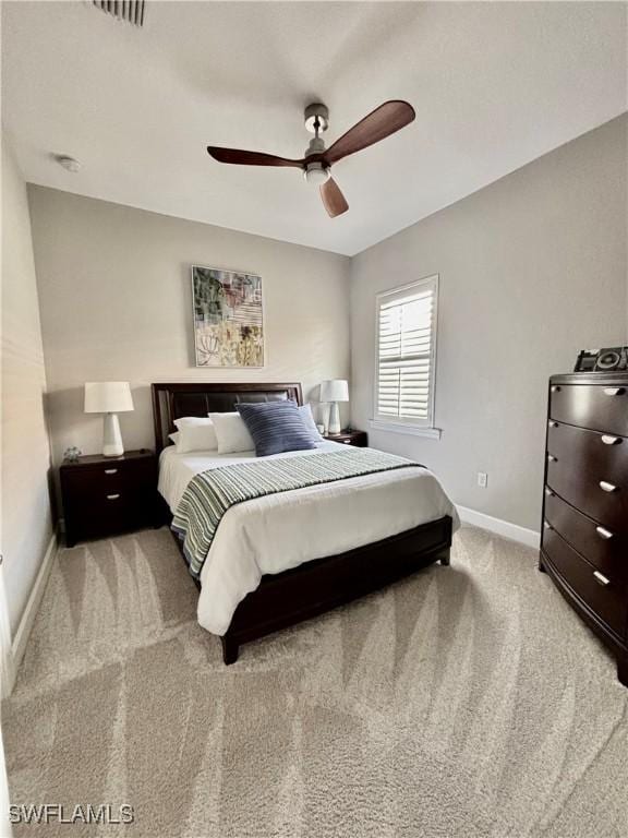 bedroom with a ceiling fan, carpet, and baseboards
