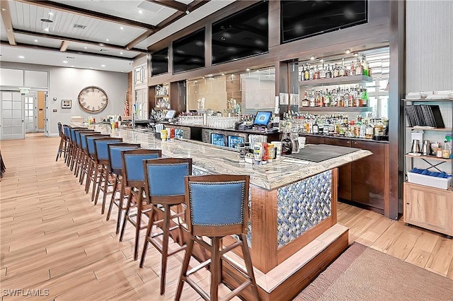 bar featuring indoor wet bar, recessed lighting, light wood-style flooring, and beamed ceiling