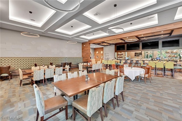 carpeted dining space featuring visible vents and coffered ceiling