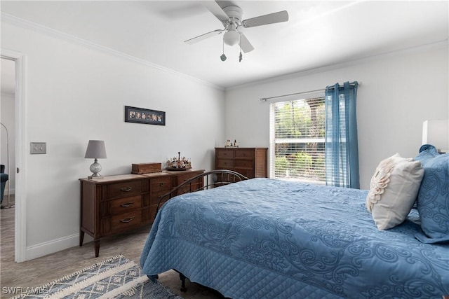bedroom with baseboards, a ceiling fan, and crown molding