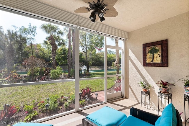 sunroom / solarium featuring ceiling fan