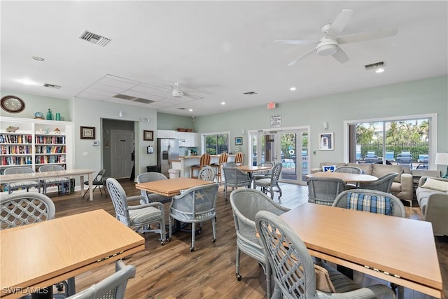 dining room featuring ceiling fan, wood finished floors, and visible vents