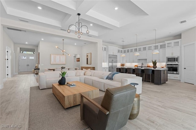 16198 Verilyn Cir, Naples, FL 34110 - living room featuring a chandelier, recessed lighting, light wood-type flooring, coffered ceiling, and beamed ceiling