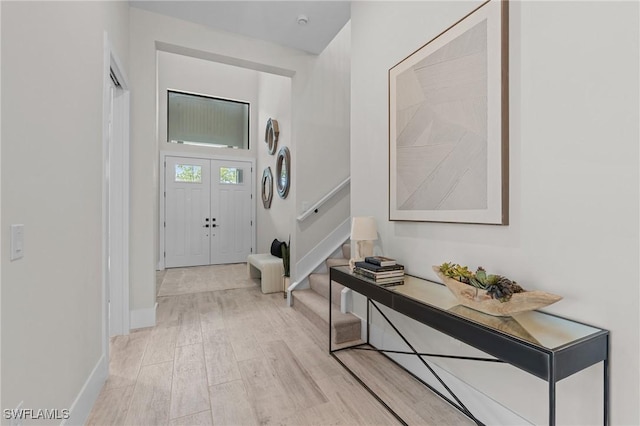 16198 Verilyn Cir, Naples, FL 34110 - entrance foyer featuring stairway, light wood-type flooring, and baseboards