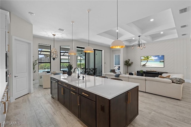 16198 Verilyn Cir, Naples, FL 34110 - kitchen featuring a sink, a chandelier, open floor plan, dark brown cabinets, and light wood-type flooring