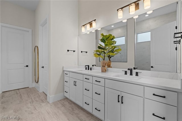 16198 Verilyn Cir, Naples, FL 34110 - bathroom with double vanity, baseboards, wood finished floors, and a shower