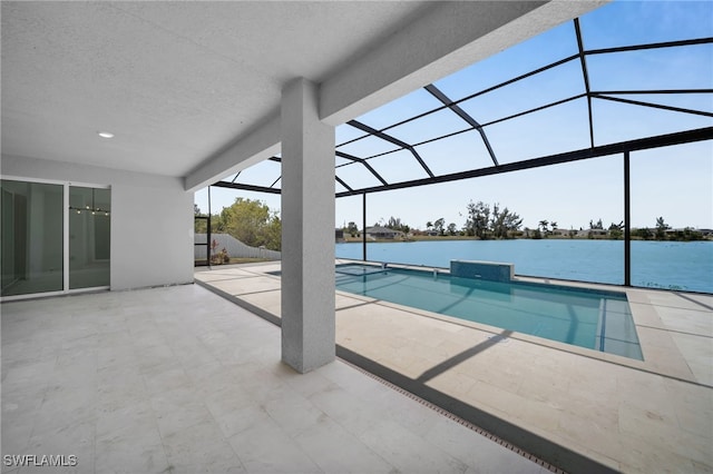 pool with a lanai, a patio area, and a water view