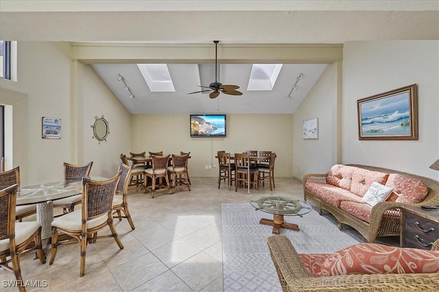 4719 SE 17th Pl Unit 208, Cape Coral, FL 33904 - living area featuring vaulted ceiling with skylight, a ceiling fan, rail lighting, and light tile patterned flooring