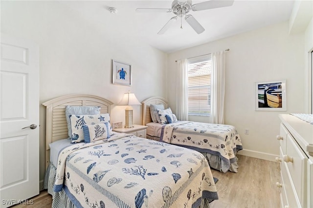 bedroom featuring baseboards, ceiling fan, and light wood-style floors