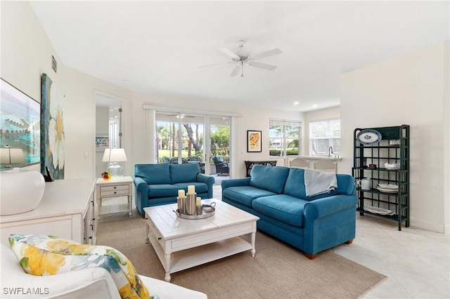 living area with light tile patterned floors, ceiling fan, and visible vents
