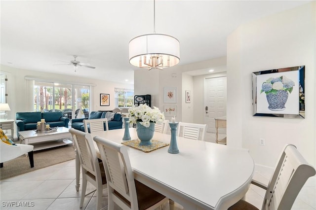 dining area featuring recessed lighting, light tile patterned floors, and ceiling fan with notable chandelier