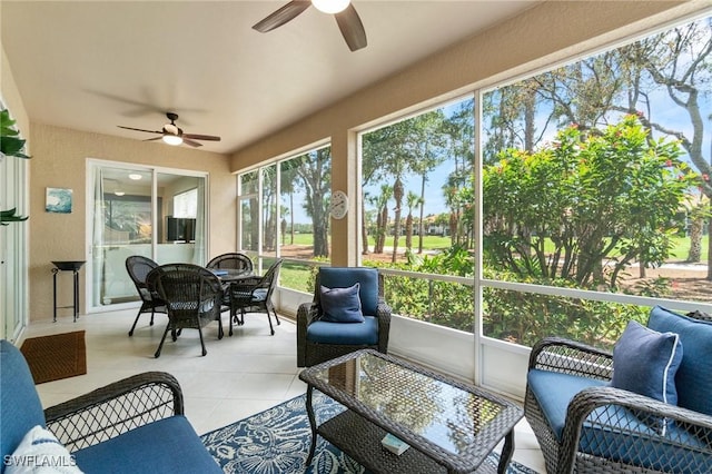 sunroom with a ceiling fan and outdoor dining space