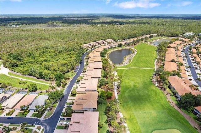 aerial view with a water view, a view of trees, a residential view, and golf course view
