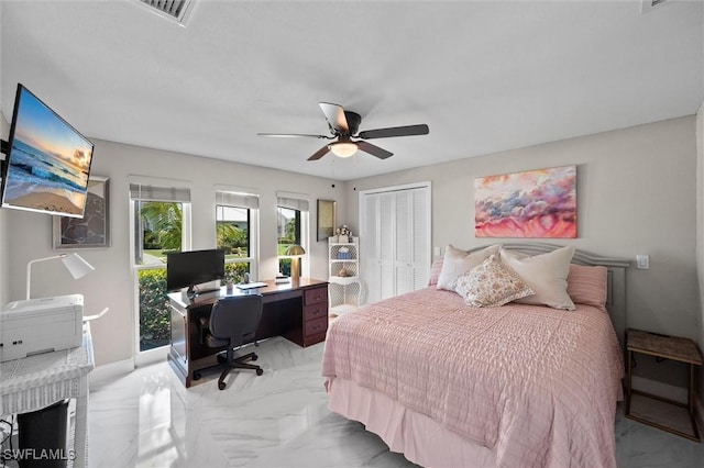bedroom featuring visible vents, baseboards, a closet, a ceiling fan, and marble finish floor