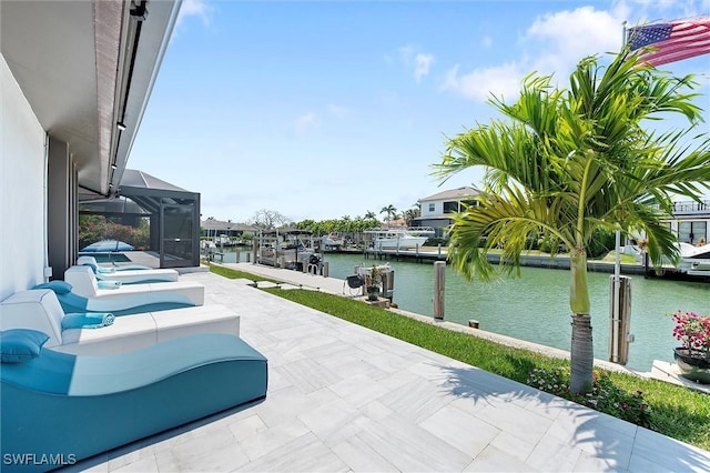 view of patio with a lanai, a dock, and a water view