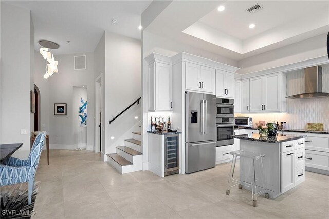 1603 Curlew Ave Unit 1603, Naples, FL 34102 - kitchen with beverage cooler, visible vents, wall chimney range hood, and high quality fridge