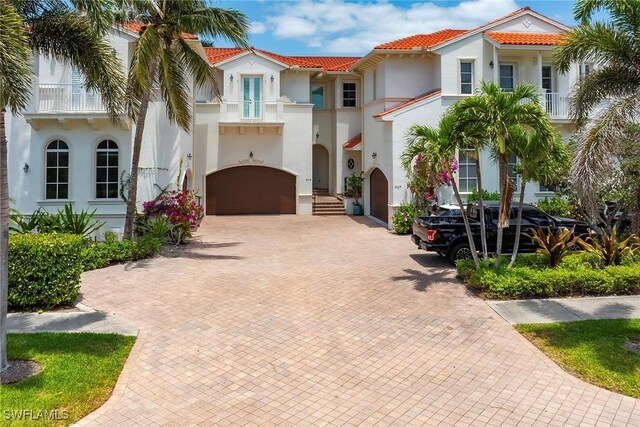 1603 Curlew Ave Unit 1603, Naples, FL 34102 - mediterranean / spanish-style house with a tiled roof, stucco siding, an attached garage, and decorative driveway
