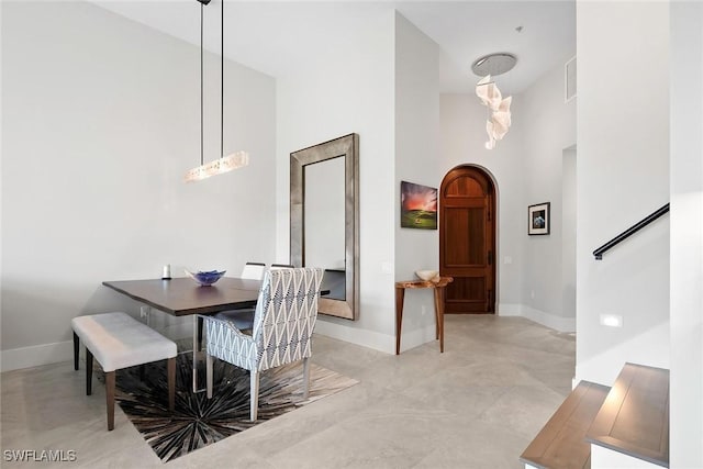 1603 Curlew Ave Unit 1603, Naples, FL 34102 - dining room featuring baseboards, a high ceiling, arched walkways, and visible vents