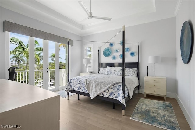 1603 Curlew Ave Unit 1603, Naples, FL 34102 - bedroom featuring a ceiling fan, access to exterior, wood finished floors, ornamental molding, and a tray ceiling