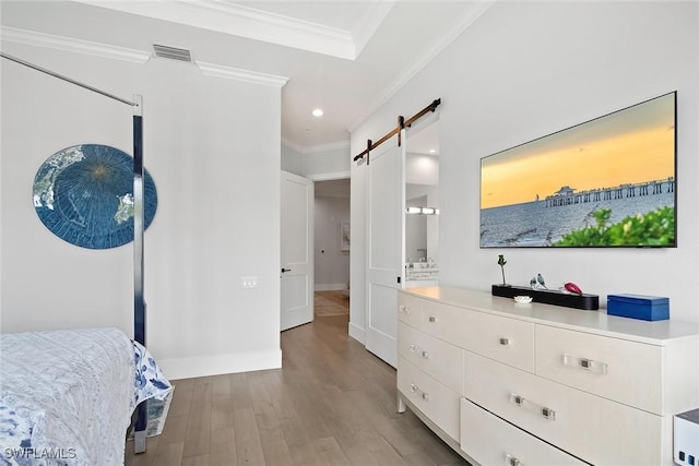 1603 Curlew Ave Unit 1603, Naples, FL 34102 - bedroom featuring a barn door, recessed lighting, wood finished floors, visible vents, and ornamental molding