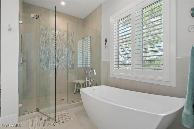 1603 Curlew Ave Unit 1603, Naples, FL 34102 - full bath with tile patterned flooring, a freestanding tub, and a stall shower