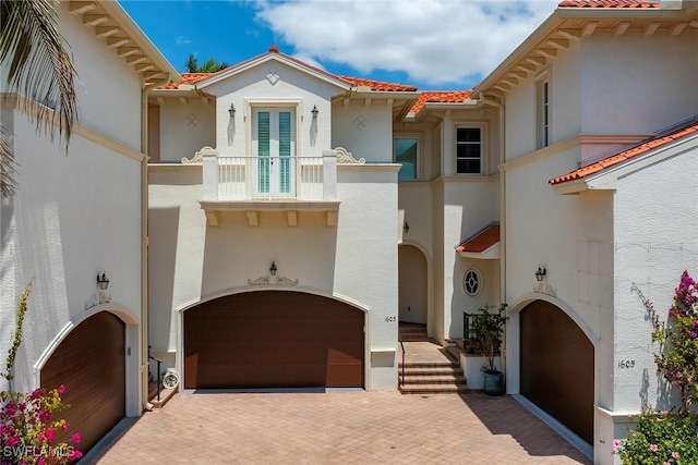 1603 Curlew Ave Unit 1603, Naples, FL 34102 - mediterranean / spanish-style home with french doors, stucco siding, a tile roof, and a balcony