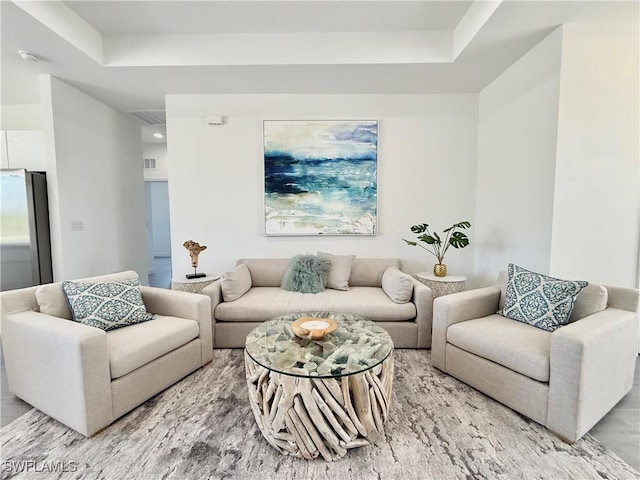 living room with visible vents and light wood-style flooring