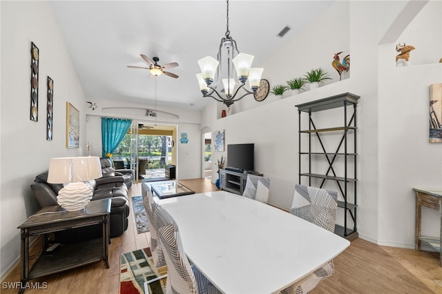 8188 Tauren Ct Unit N342, Naples, FL 34119 - dining room featuring wood finished floors, vaulted ceiling, ceiling fan with notable chandelier, baseboards, and visible vents