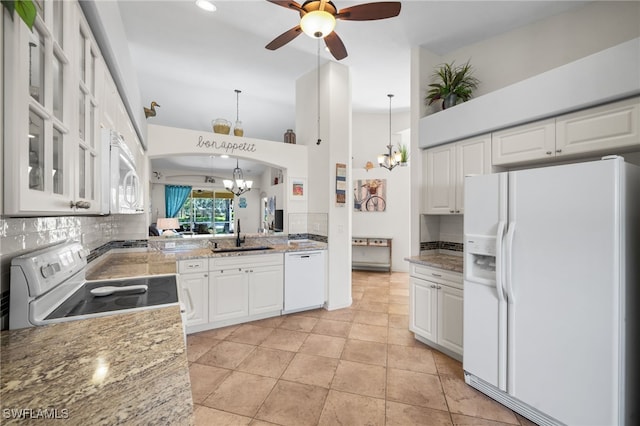 8188 Tauren Ct Unit N342, Naples, FL 34119 - kitchen with a sink, tasteful backsplash, white cabinetry, white appliances, and ceiling fan with notable chandelier