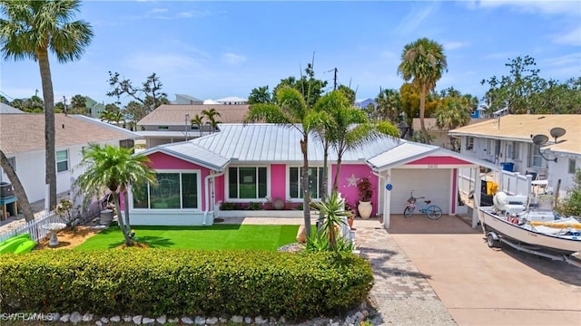 3410 Shell Mound Blvd, Fort Myers Beach, FL 33931 - single story home with concrete driveway, metal roof, and a front lawn