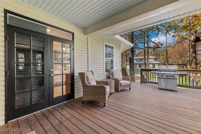 wooden deck with french doors and area for grilling