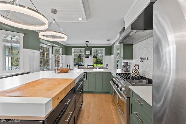 5271 Cherry Wood Dr, Naples, FL 34119 - kitchen with green cabinets, stainless steel appliances, light countertops, ventilation hood, and light wood finished floors