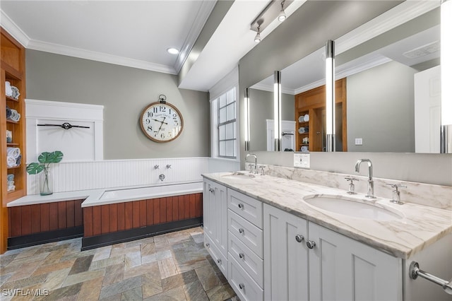 full bathroom featuring a sink, ornamental molding, stone finish flooring, and double vanity